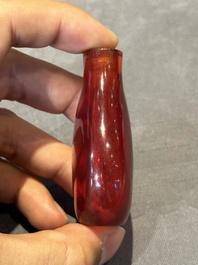 A group of seven Chinese red-overlay glass and red glass snuff bottles, 19/20th C.