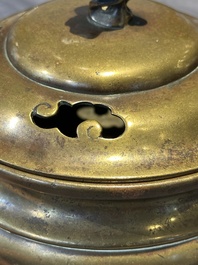 A Chinese bronze tripod censer with cover and stand, 19th C.
