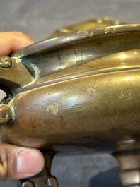 A Chinese bronze tripod censer with cover and stand, 19th C.