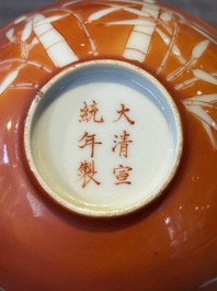 A Chinese coral-red-glazed bowl with reverse-decorated bamboo design, Xuantong mark and of the period