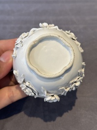 A Chinese blue and white 'butterfly' cup and saucer with applied floral design, Qianlong