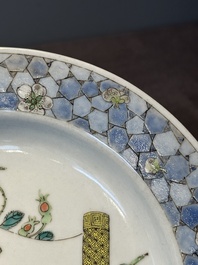 A fine Chinese famille rose 'ruby back' plate with a bird on a blossoming branch, Yongzheng