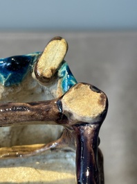 A Chinese turquoise- and aubergine-glazed sculpture of a seated scholar, 18/19th C.