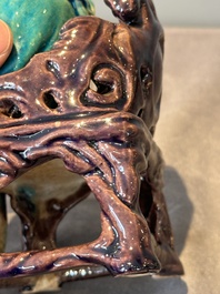 A Chinese turquoise- and aubergine-glazed sculpture of a seated scholar, 18/19th C.
