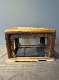 A Chinese rectangular huanghuali wooden stool with 'chilong' design, 17/18th C.