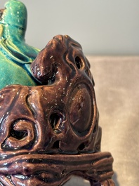 A Chinese turquoise- and aubergine-glazed sculpture of a seated scholar, 18/19th C.