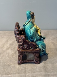 A Chinese turquoise- and aubergine-glazed sculpture of a seated scholar, 18/19th C.