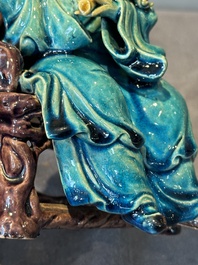 A Chinese turquoise- and aubergine-glazed sculpture of a seated scholar, 18/19th C.