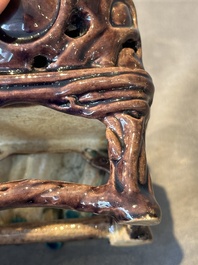 A Chinese turquoise- and aubergine-glazed sculpture of a seated scholar, 18/19th C.