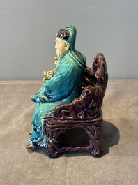 A Chinese turquoise- and aubergine-glazed sculpture of a seated scholar, 18/19th C.