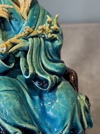 A Chinese turquoise- and aubergine-glazed sculpture of a seated scholar, 18/19th C.