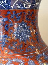 A Chinese blue and white, and iron-red 'bajixiang' 'hu' vase on wooden stand, Qianlong mark, 19th C.