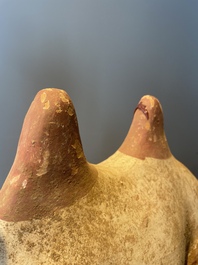 A pair of Chinese polychrome-painted terracotta camels with saddles, Tang