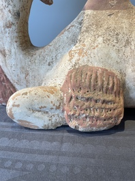 A pair of Chinese polychrome-painted terracotta camels with saddles, Tang