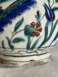 A polychrome and gilt Iznik ewer with tulips, carnation flowers and saz leaves, Turkey, ca. 1600