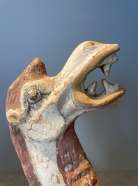 A pair of Chinese polychrome-painted terracotta camels with saddles, Tang