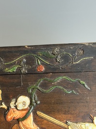 A square Chinese embellished and lacquered wooden box depicting a musician and two boys, Qing
