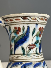 A polychrome and gilt Iznik ewer with tulips, carnation flowers and saz leaves, Turkey, ca. 1600