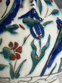 A polychrome and gilt Iznik ewer with tulips, carnation flowers and saz leaves, Turkey, ca. 1600