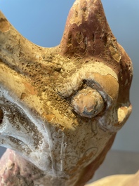 A pair of Chinese polychrome-painted terracotta camels with saddles, Tang