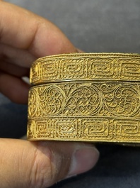 An oval Chinese imperial gold and silver filigree lidded 'dragon' box on reticulated stand and with presentation box, Qianlong mark and of the period