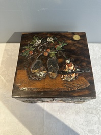 A square Chinese embellished and lacquered wooden box depicting a musician and two boys, Qing