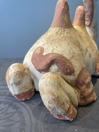 A pair of Chinese polychrome-painted terracotta camels with saddles, Tang
