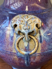 A large Chinese flamb&eacute; glaze 'hu' vase with Taotie handles, Qing