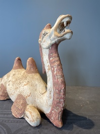 A pair of Chinese polychrome-painted terracotta camels with saddles, Tang