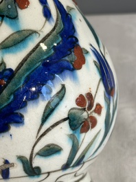 A polychrome and gilt Iznik ewer with tulips, carnation flowers and saz leaves, Turkey, ca. 1600