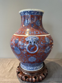 A Chinese blue and white, and iron-red 'bajixiang' 'hu' vase on wooden stand, Qianlong mark, 19th C.