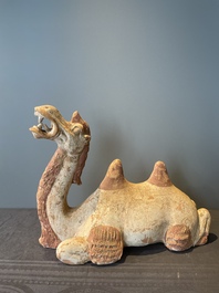 A pair of Chinese polychrome-painted terracotta camels with saddles, Tang