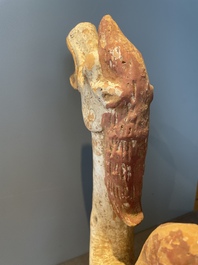 A pair of Chinese polychrome-painted terracotta camels with saddles, Tang