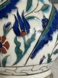 A polychrome and gilt Iznik ewer with tulips, carnation flowers and saz leaves, Turkey, ca. 1600