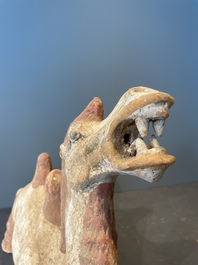 A pair of Chinese polychrome-painted terracotta camels with saddles, Tang