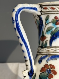 A polychrome and gilt Iznik ewer with tulips, carnation flowers and saz leaves, Turkey, ca. 1600