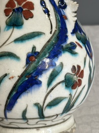 A polychrome and gilt Iznik ewer with tulips, carnation flowers and saz leaves, Turkey, ca. 1600