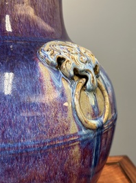 A large Chinese flamb&eacute; glaze 'hu' vase with Taotie handles, Qing