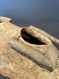 A pair of Chinese polychrome-painted terracotta camels with saddles, Tang