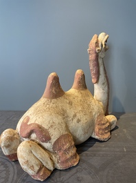 A pair of Chinese polychrome-painted terracotta camels with saddles, Tang