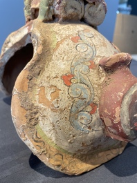 A pair of Chinese polychrome-painted terracotta camels with saddles, Tang