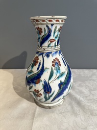 A polychrome and gilt Iznik ewer with tulips, carnation flowers and saz leaves, Turkey, ca. 1600