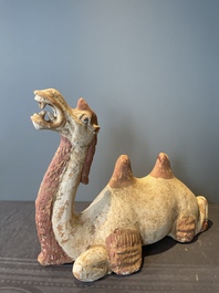 A pair of Chinese polychrome-painted terracotta camels with saddles, Tang