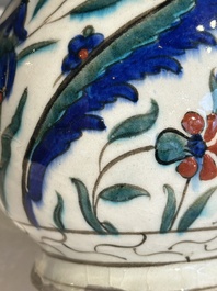 A polychrome and gilt Iznik ewer with tulips, carnation flowers and saz leaves, Turkey, ca. 1600