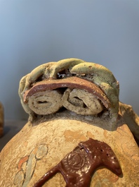 A pair of Chinese polychrome-painted terracotta camels with saddles, Tang