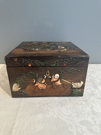 A square Chinese embellished and lacquered wooden box depicting a musician and two boys, Qing