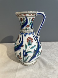 A polychrome and gilt Iznik ewer with tulips, carnation flowers and saz leaves, Turkey, ca. 1600