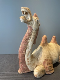 A pair of Chinese polychrome-painted terracotta camels with saddles, Tang