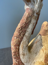 A pair of Chinese polychrome-painted terracotta camels with saddles, Tang