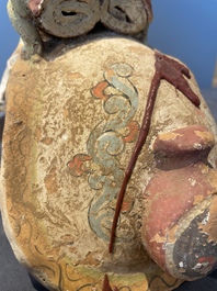A pair of Chinese polychrome-painted terracotta camels with saddles, Tang